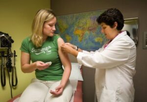 Courtney Banzer, 27, receives an HPV vaccine from Dana Varon at Harborview Women's Research clinic in Seattle. (Benjamin Benschneider/Seattle Times/MCT)